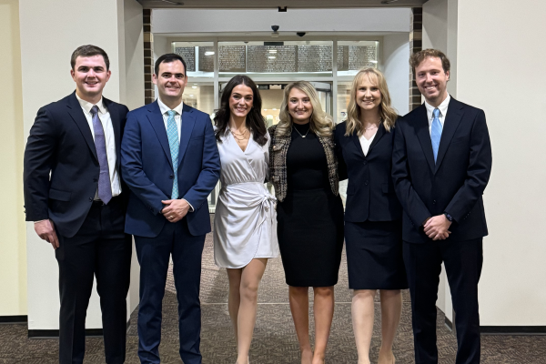 Moot Court students standing in front of a doorway. 