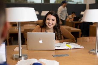 Student smiling in the library