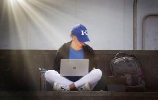Student using computer outside