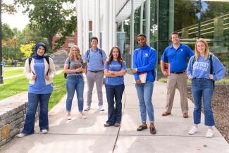 law students standing outside of the law building, wearing UK attire