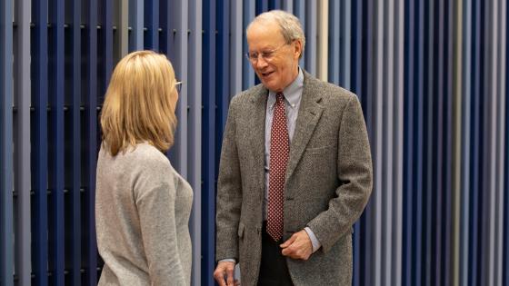 Faculty members speaking to each other
