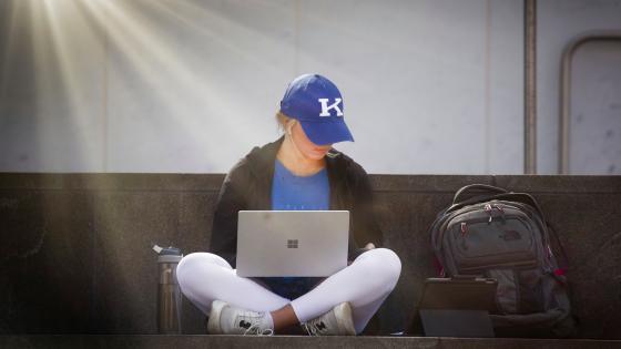 Student using computer outside