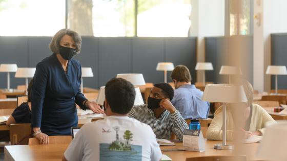 dean speaks with students in the law library