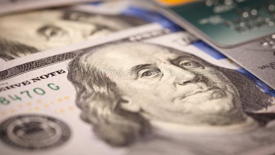 Extreme closeup of a U.S. $100 bill with a shallow depth of field, focused on Benjamin Franklin's oddly disapproving face.