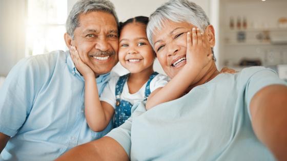 Grandparents taking a selfie with grandchild.