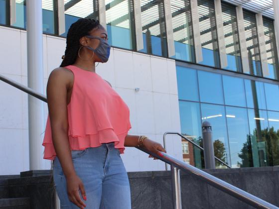 Student in front of Law Building