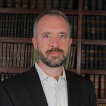 Man standing in front of bookcase