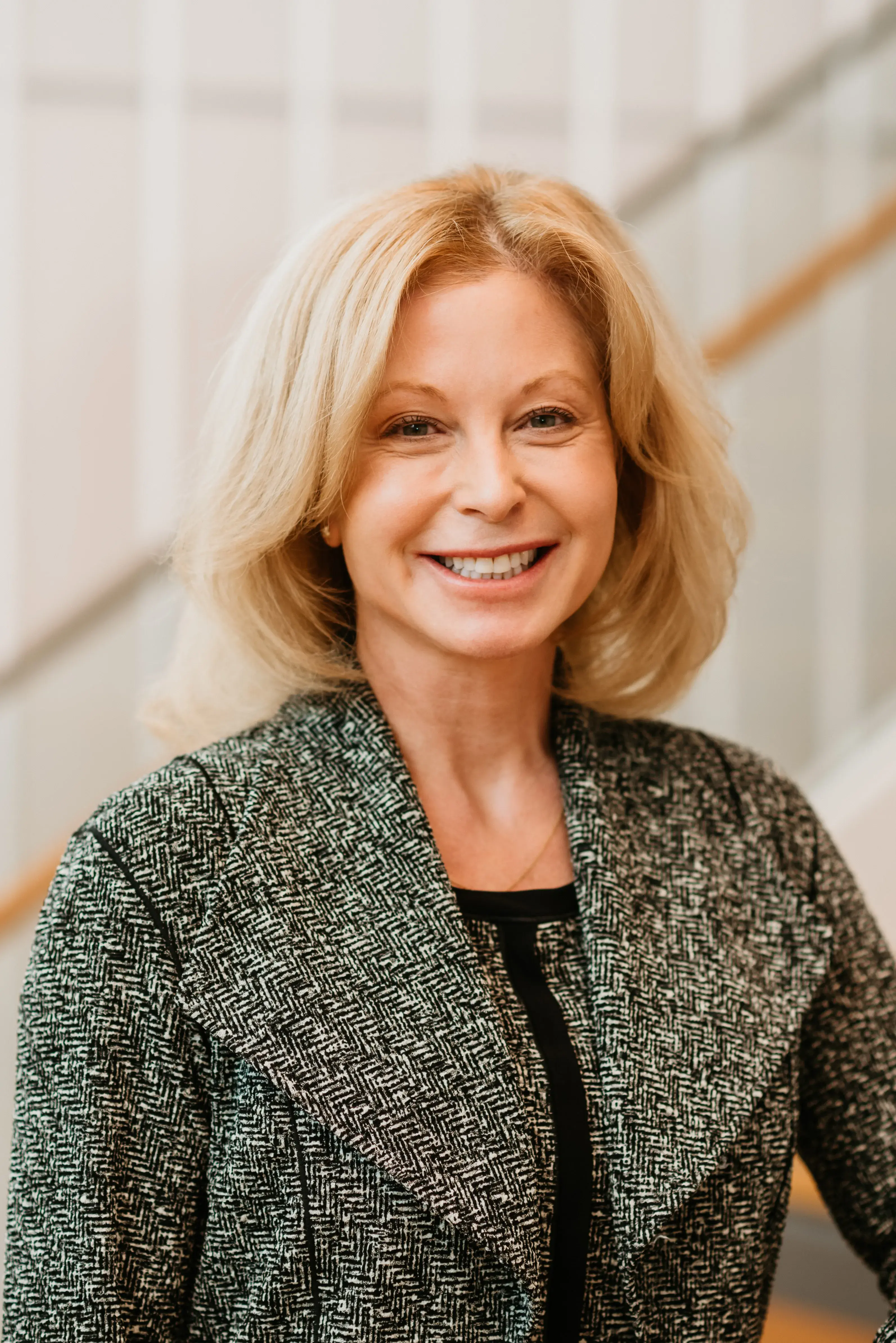 Mary Forsester standing in front of a staircase.