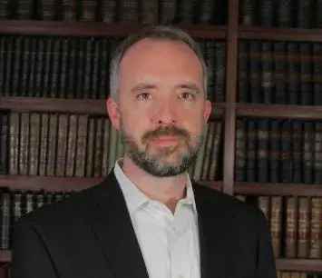Man standing in front of bookcase